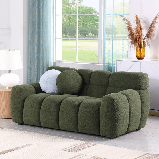 Green Upholstered Sofa Bed with round cushion in bright living room setting, surrounded by natural light.