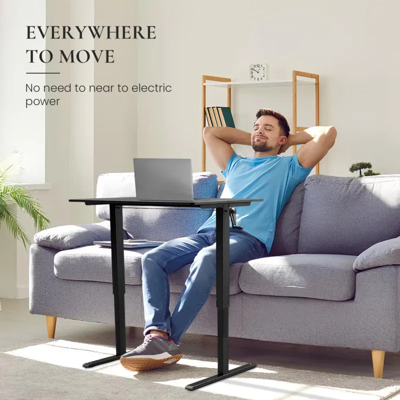 Man relaxing on a couch with a hand-crank adjustable desk and laptop, showcasing versatility in workspace.